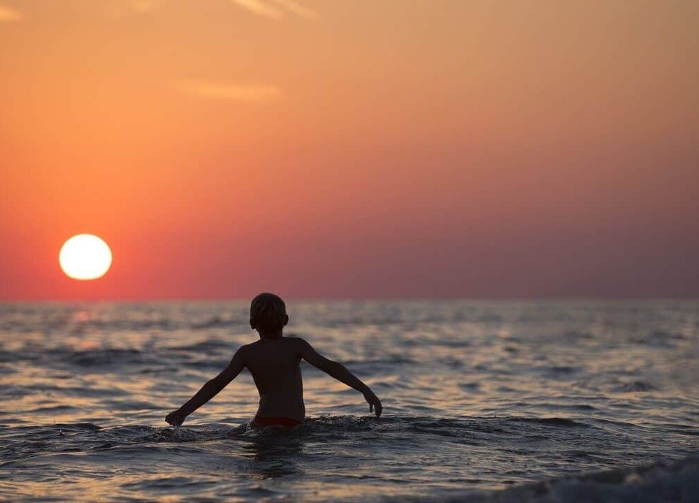 boy playing in the sea