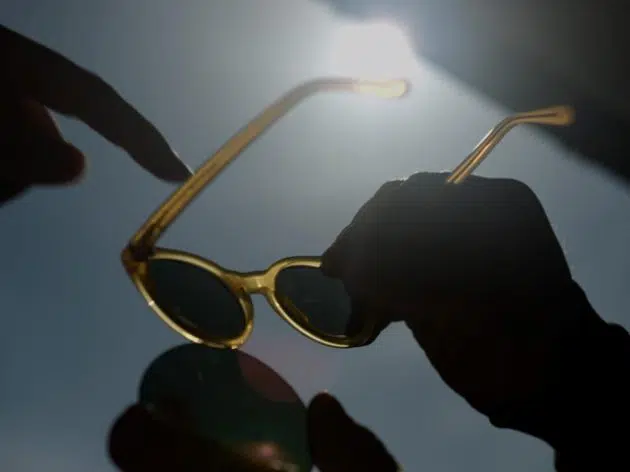 hands holding pair of sustainable Pala sunglasses