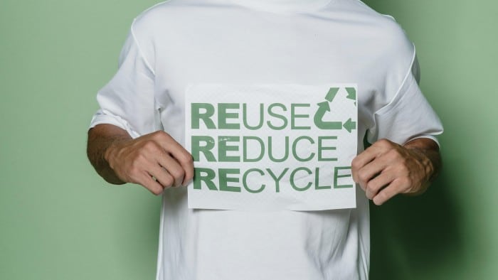man holding recycle sign