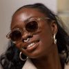 thoko oyster 1 front woman wearing sustainable transparent round sunglasses made from bioacetate