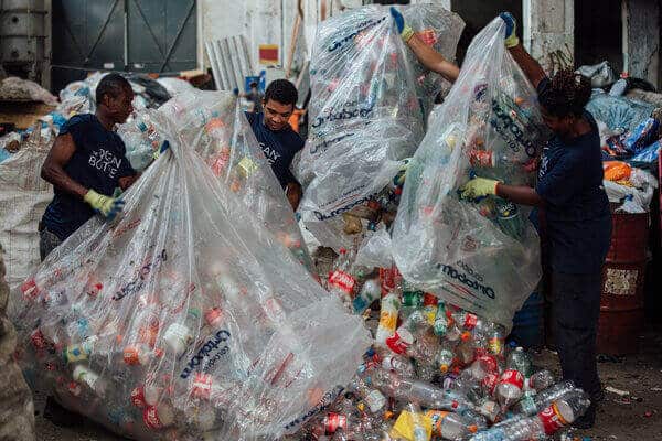 Plastic collectors sorting ocean bound single use plastic