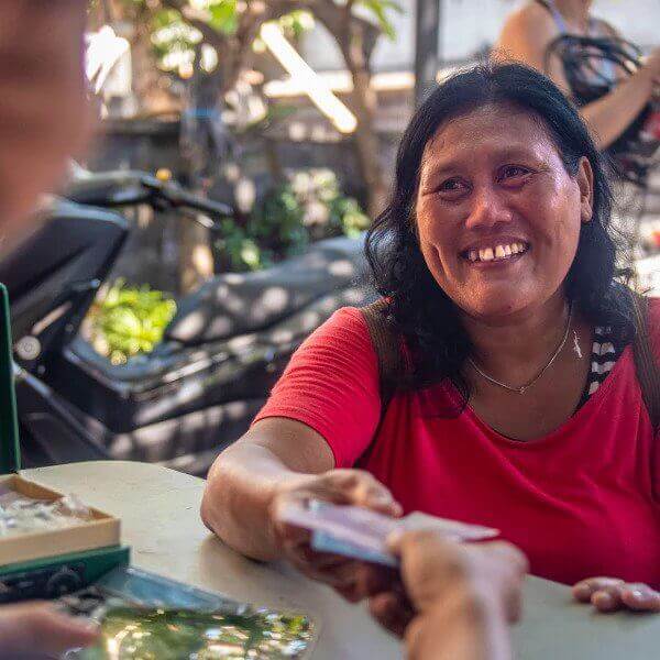 Plastic collector in Indonesia being paid for work