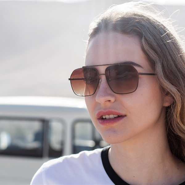 Itri Bronze - Archive Sale 3 woman wearing angular aviator sunglasses with brown lenses
