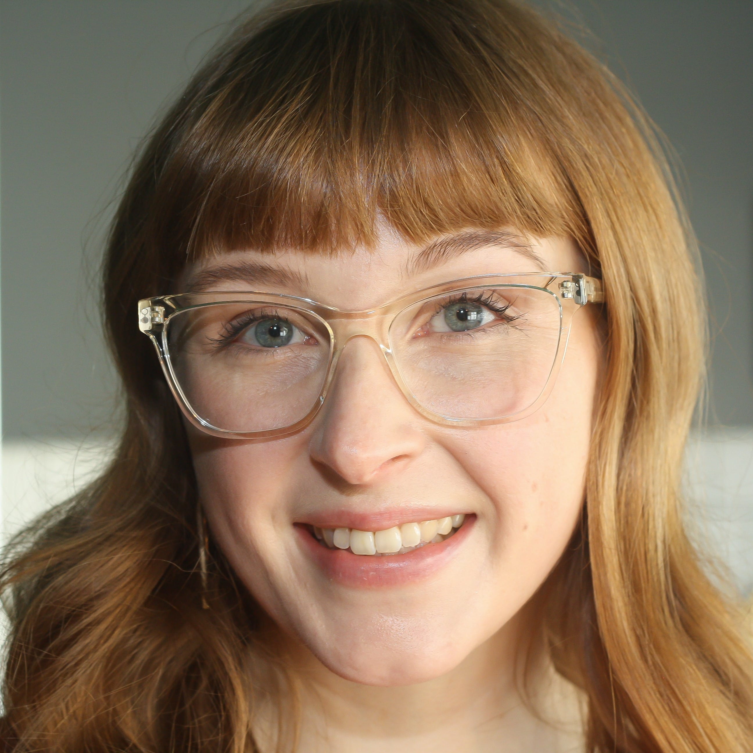 Copy of Anansa Almond 2023 Woman wearing blue light blocking glasses in a clear cat eye shape.