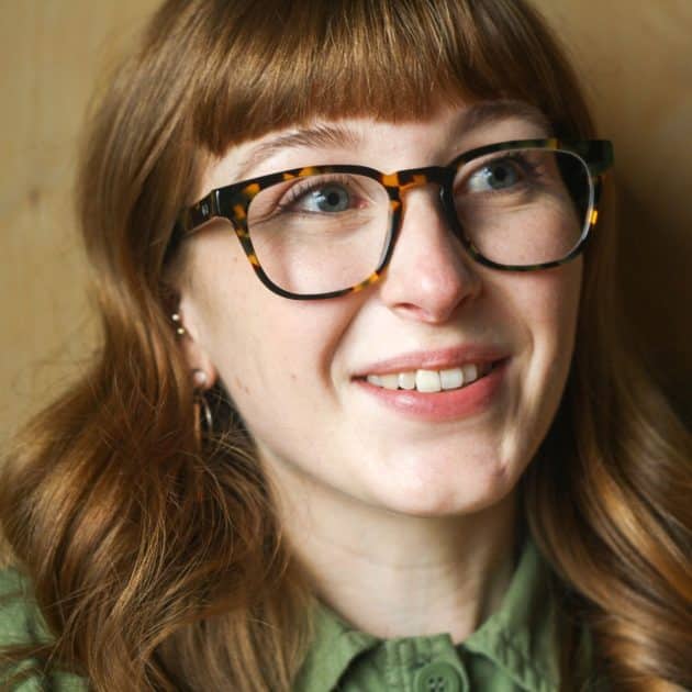 Classic square tortoiseshell glasses with a keyhole nose bridge detail being worn by a woman.
