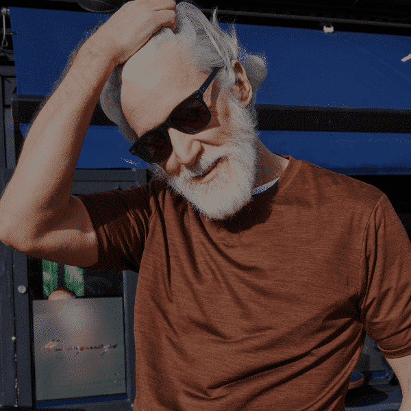 Stylish middle aged man wearing black wayfarer sustainable sunglasses