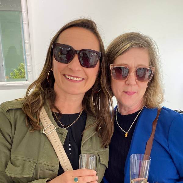 Two stylish middle aged women wearing glamorous oversized sunglasses - the Pala Thabo frame.